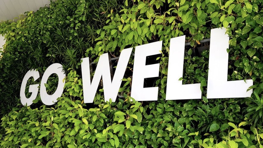 Go Well signage on a living green wall at a Shell site